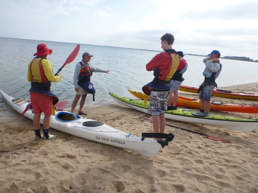 Mallacoota P12 College students listen to sea kayak guide Derek Wigley before embarking on a five-day paddle across the length of the Gippsland Lakes.