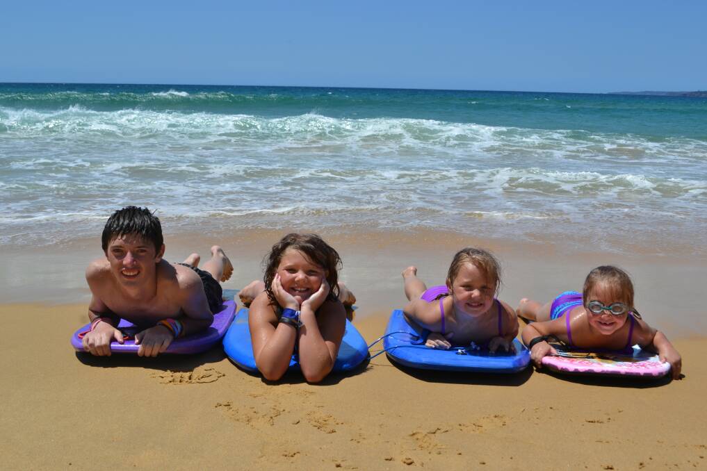 The Lamont family from Queanbeyan are holidaying on the Far South Coast this week.  From left they are AJ (14), Taylor (9), Zoe (7), and Chenille (6) Lamont,  pictured enjoying the surf at Aslings Beach today.