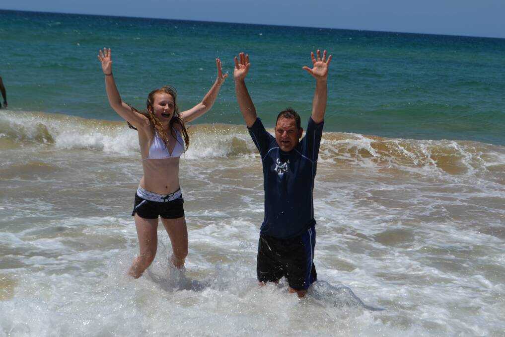 Dad Gerard and daughter Michaela are taking their summer holiday in Eden.  They had a ball in the surf at Aslings Beach on Friday.